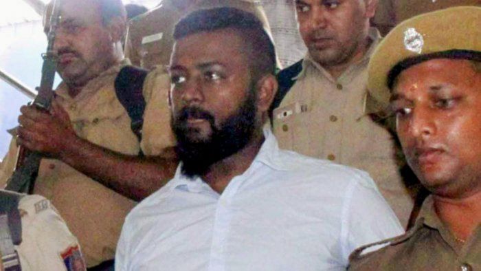 <div class="paragraphs"><p>Alleged conman Sukesh Chandrasekhar being escorted by the police.</p></div>