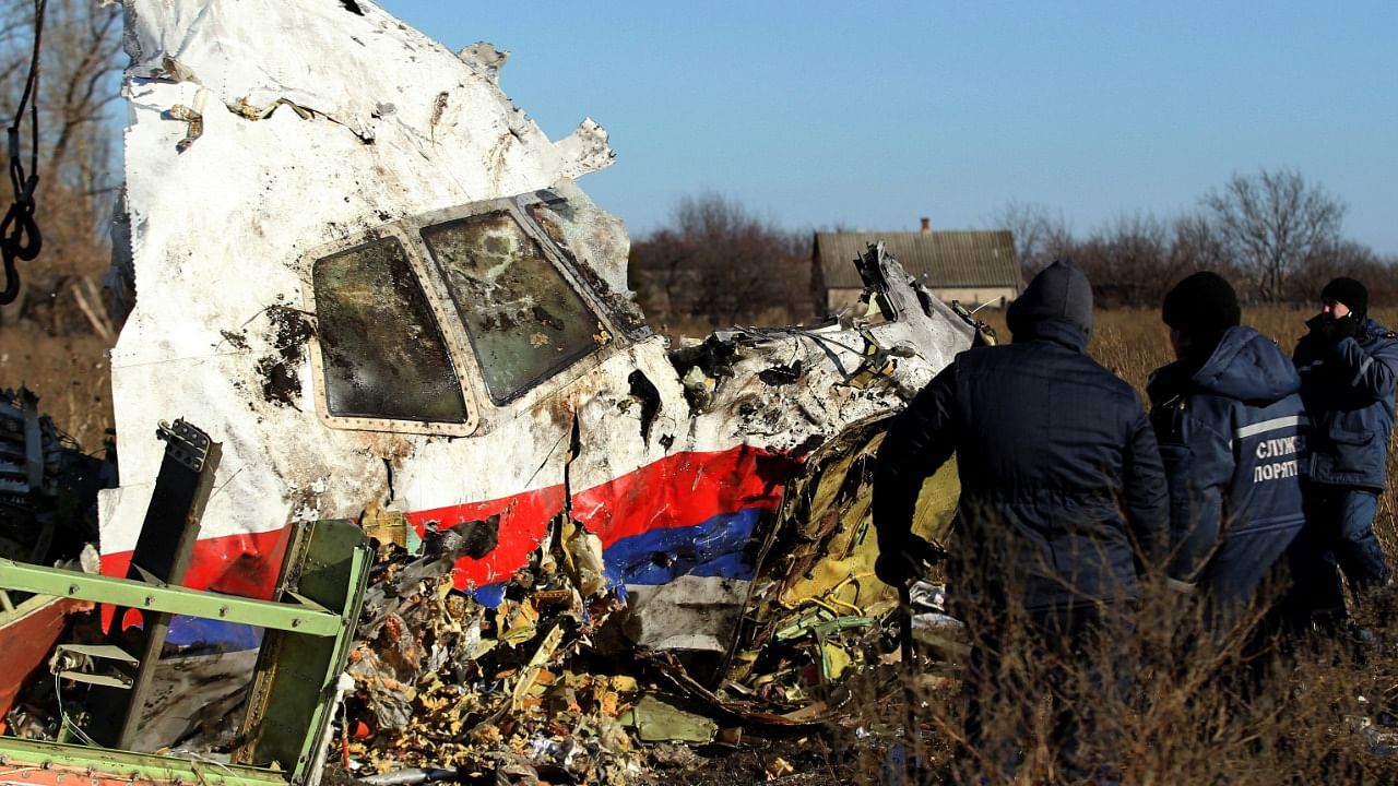 Local workers transport a piece of wreckage from Malaysia Airlines flight MH17 at the site of the plane crash near the village of Hrabove (Grabovo) in Donetsk region. Credit: Reuters Photo