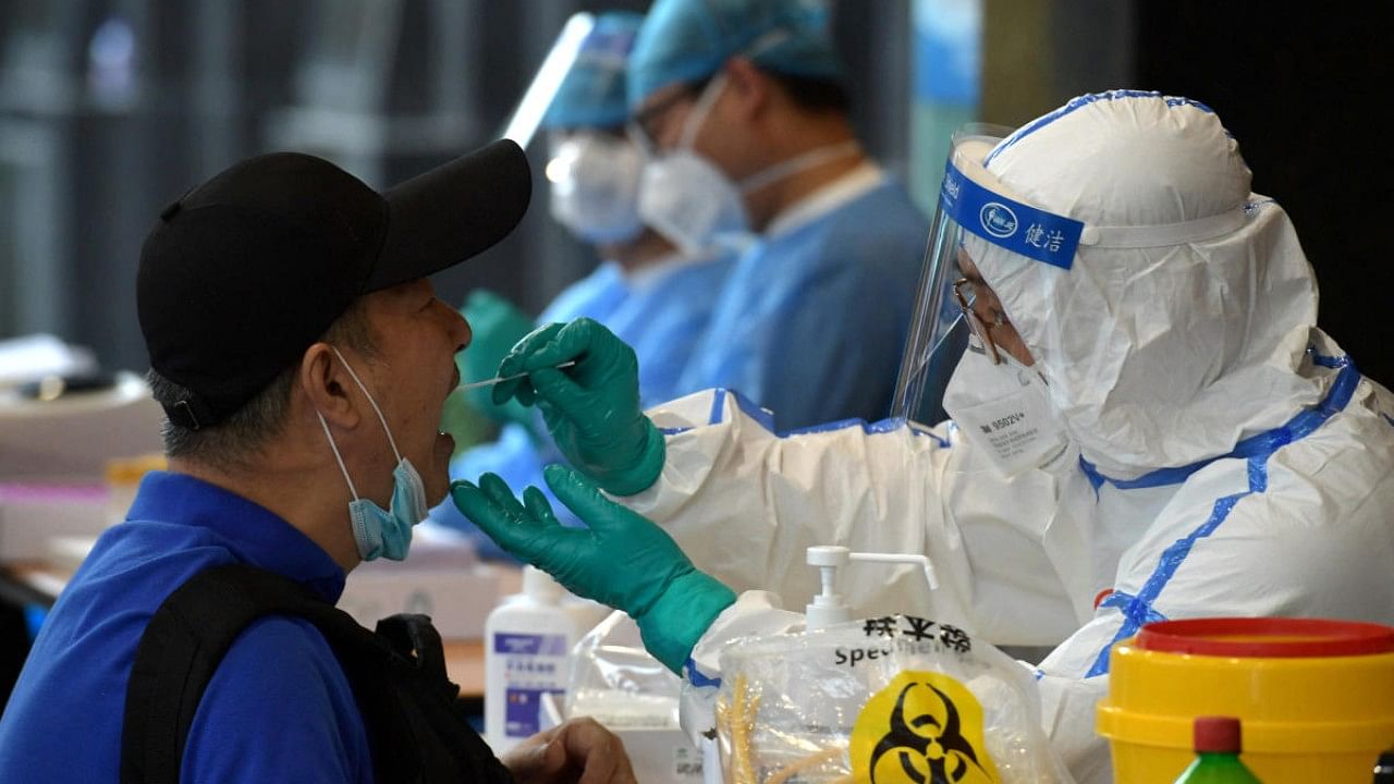 Medical staff collects swabs from people who have recently travelled to Beijing for nucleic acid tests, in Nanjing. Credit: Reuters File Photo
