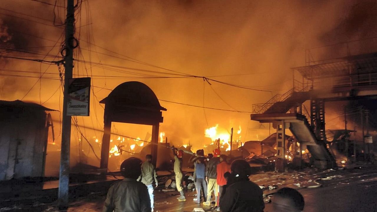 Firefighters try to douse a fire that broke out at a market in Jorhat district. Credit: PTI Photo