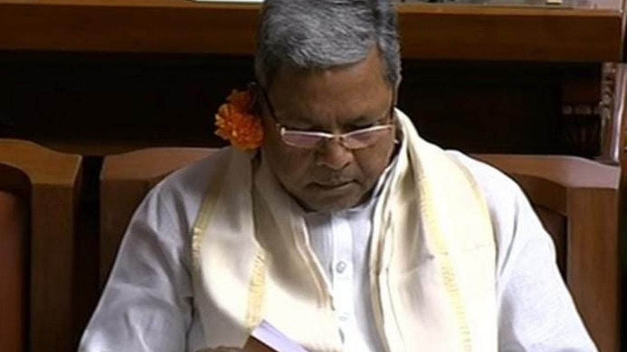 Leader of Opposition and former CM Siddaramaiah with flower on his ear. Credit: Twitter/ @ANI