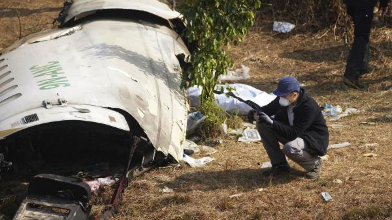 Investigator at the site of the Nepal plane crash. Credit: AP/PTI