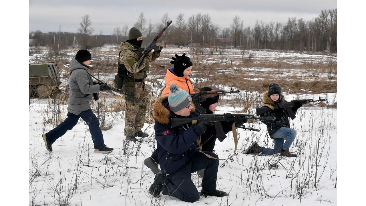 Children handle weapons at a family tank park in Saint Petersburg. Credit: AFP