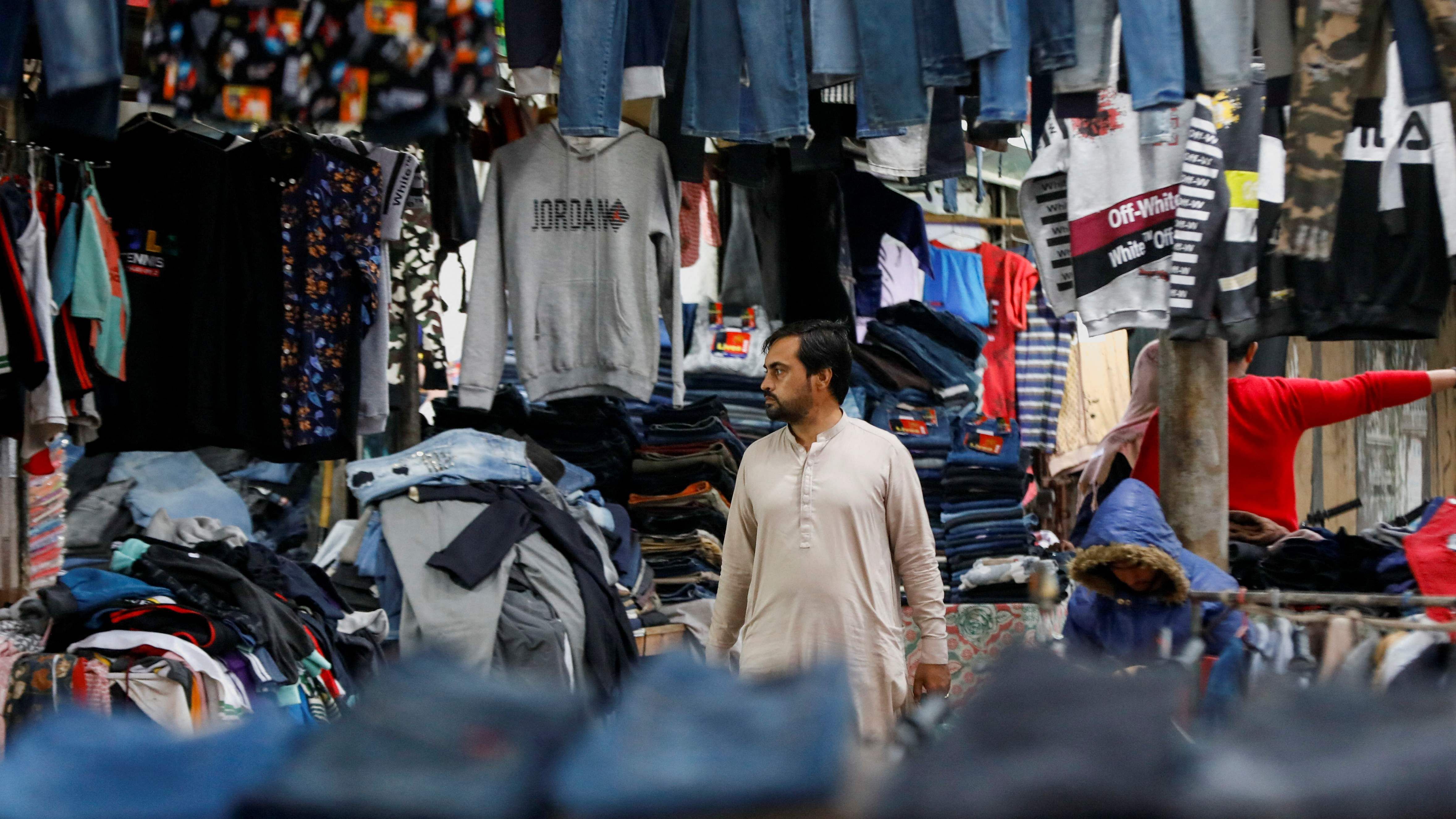 A man walks past secondhand clothes at the Landa Bazar in Karachi, Pakistan January 15, 2023.  Credit: Reuters Photo