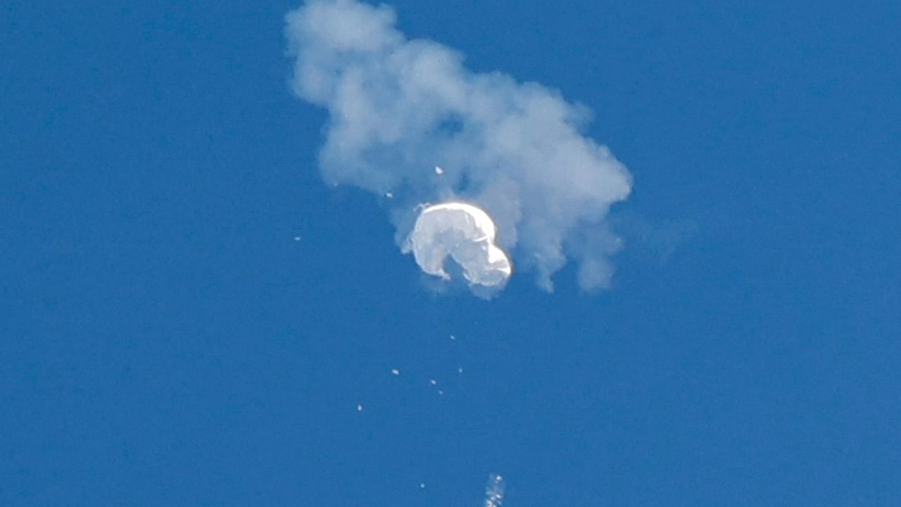 The suspected Chinese spy balloon drifts to the ocean after being shot down off the coast in Surfside Beach. Credit: Reuters Photo