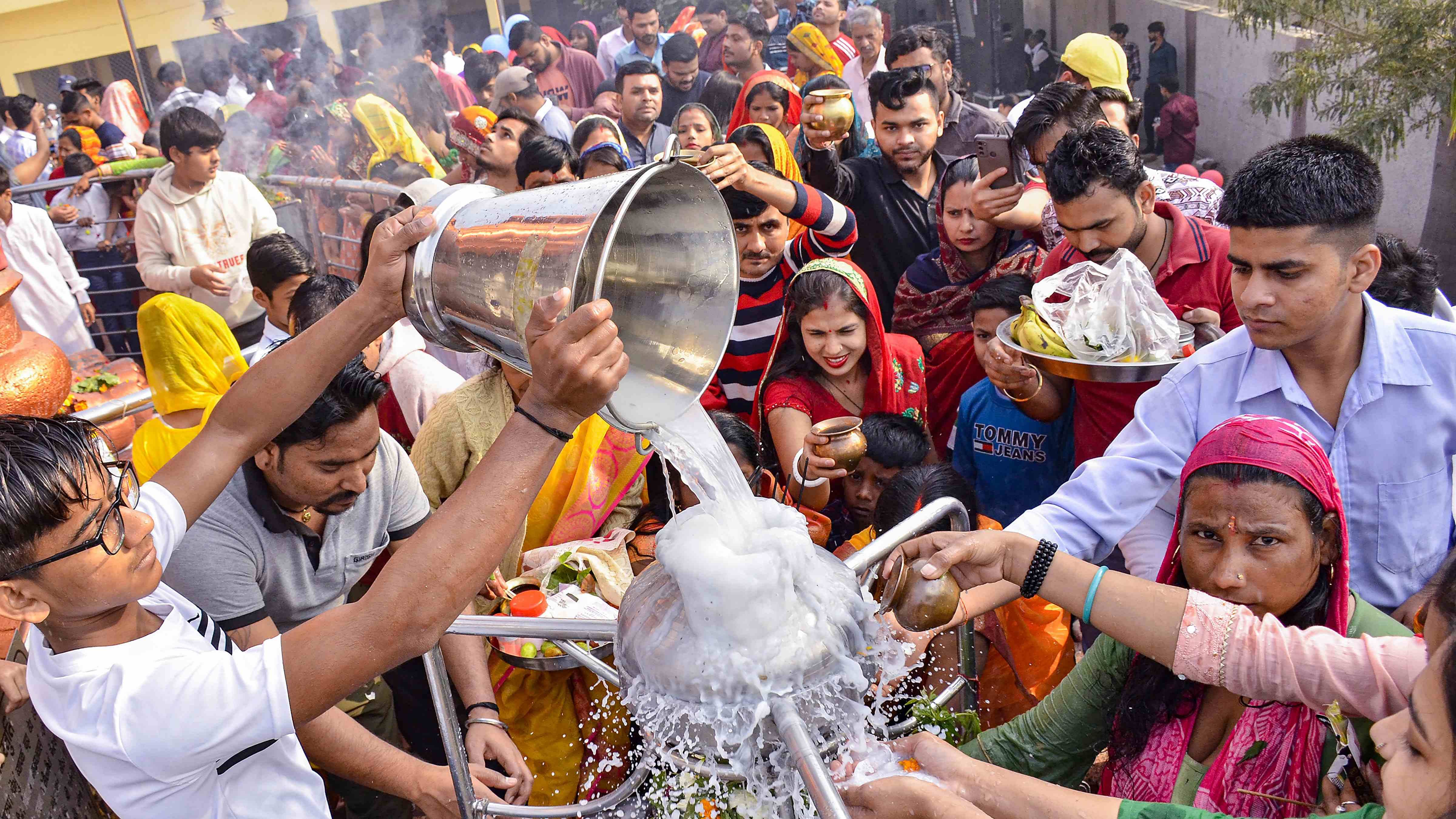 Devotees perform 'abhishek' of a 'Shivling' at Shiv temple on the occasion of Mahashivratri festival, in Gurugram. Credit: PTI Photo