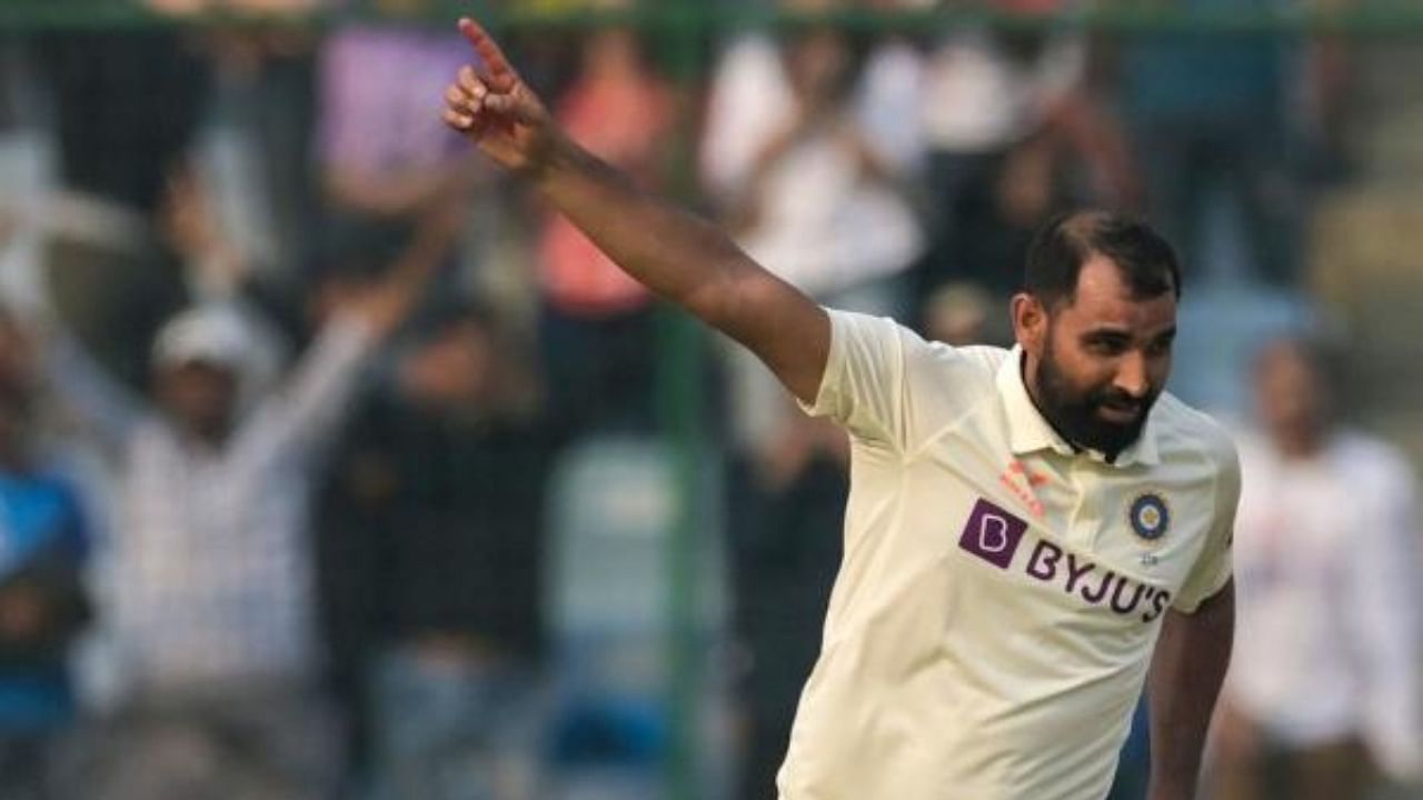 India's Mohammed Shami celebrates after taking the wicket of Australia's Matthew Kuhnemann. Credit: AFP Photo