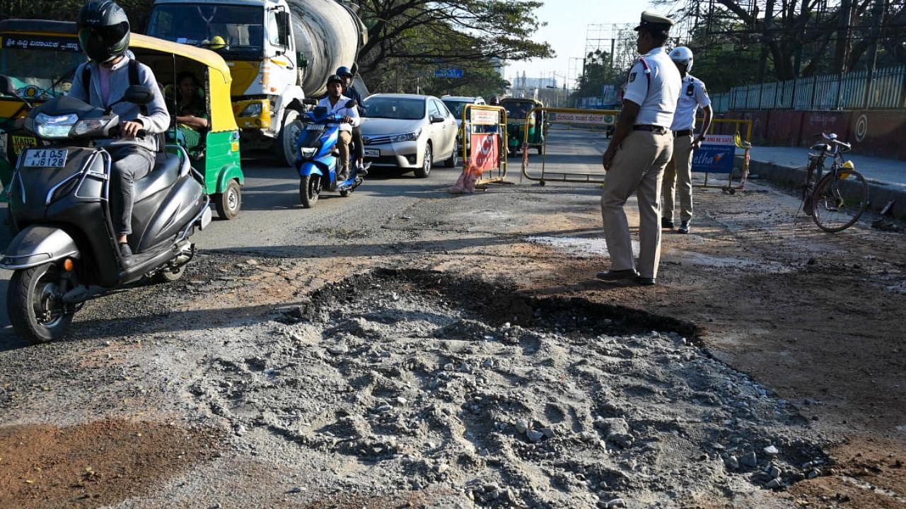 A pothole was created after a possible water leak on the busy Hosur Road in Bengaluru. Credit: DH File Photo/ Pushkar V