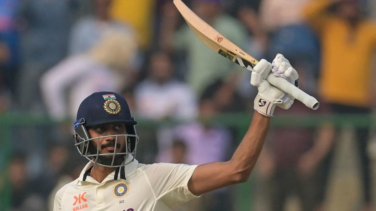  Axar Patel raises his bat after scoring a half century during the 2nd day of the 2nd test cricket match between India and Australia. Credit: PTI 