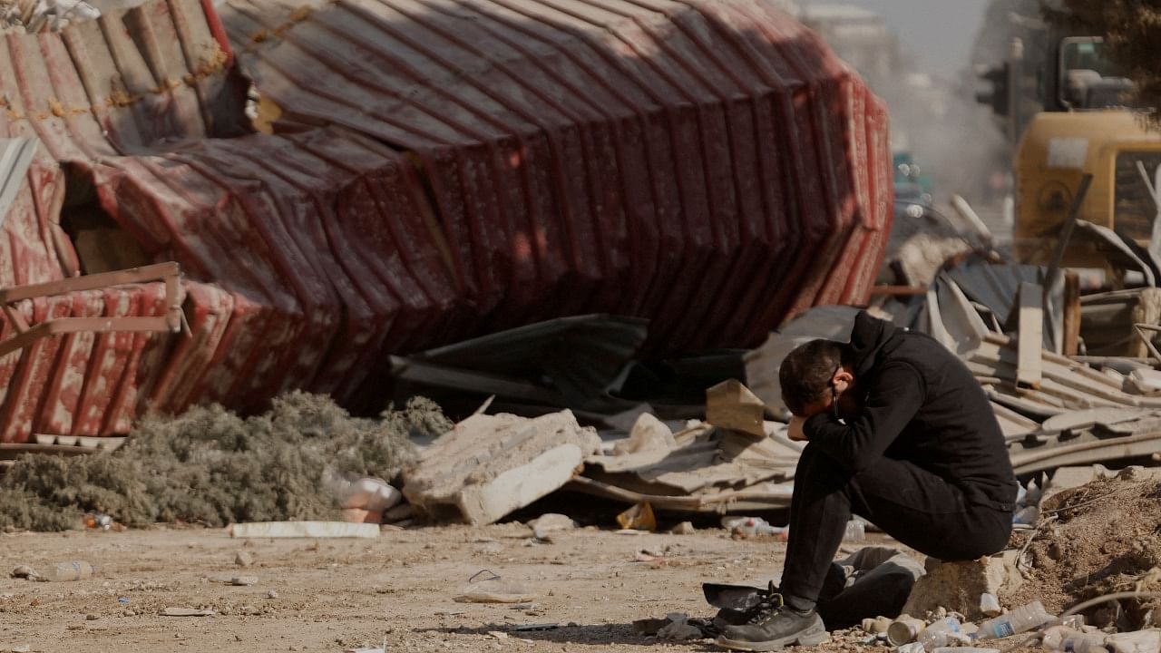 A man reacts as people search the rubble of collapsed apartment blocks for personal belongings, in the aftermath of a deadly earthquake, in Kahramanmaras, Turkey, February 18, 2023. Credit: Reuters Photo