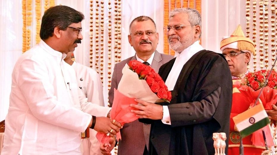 Jharkhand Chief Minister Hemant Soren congratulates new Chief Justice of Jharkhand High Court Sanjay Kumar Mishra during swearing in ceremony a