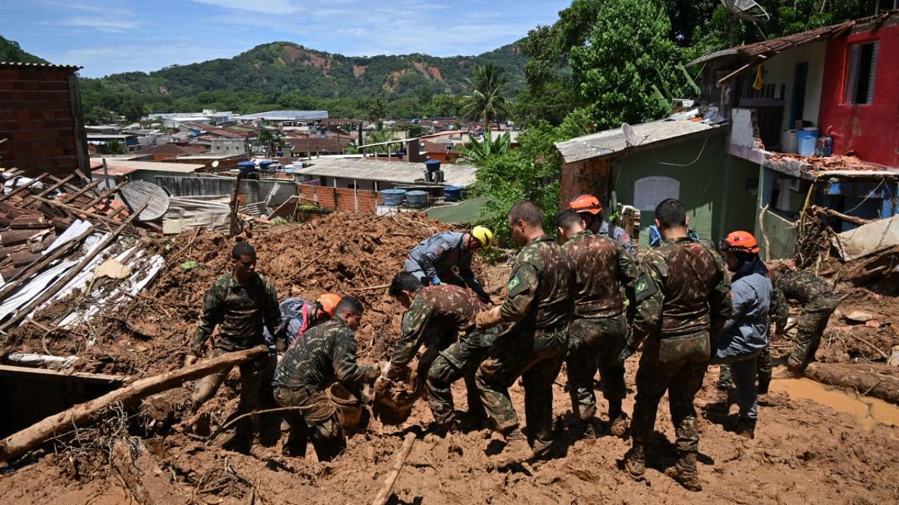 Rescue personnel work at a flood-affected area in Barra do Sahy, Sao Sebastiao district, Sao Paulo state, Brazil. Credit: AFP Photo