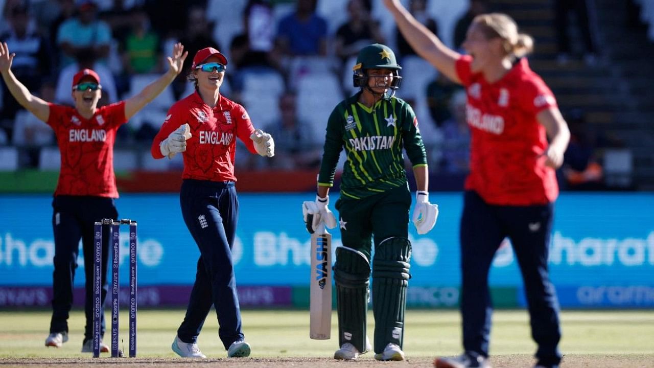 Pakistan's Sidra Nawaz (2nd R) reacts after being run out by England's Katherine Sciver-Brunt (R) as England's wicketkeeper Amy Jones (2nd L) reacts during the Group B T20 women's World Cup cricket match between England and Pakistan at Newlands Stadium in Cape Town. Credit: AFP Photo