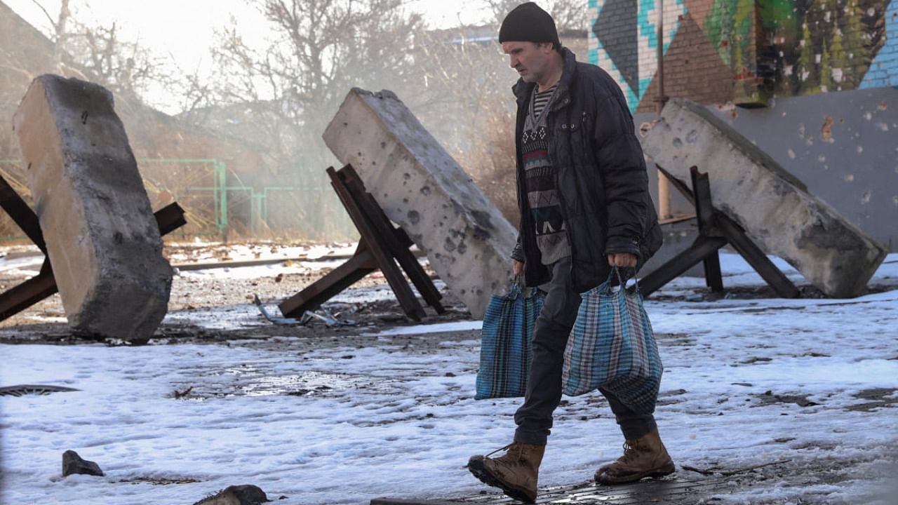 A local resident walks along a street in the frontline city of Bakhmut, amid Russia's attack on Ukraine, in Donetsk region, Ukraine February 19, 2023. Credit: Reuters Photo