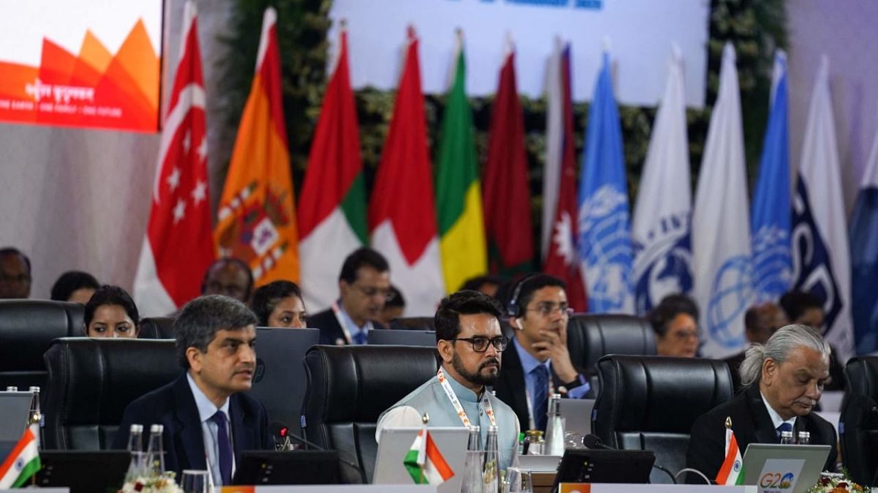 This handout photo taken and released by India's Press Information Bureau (PIB) on February 22, 2023 shows Anurag Thakur (C), India's Union Minister for Information and Broadcasting, and Ajay Seth (L), secretary of India's Department of Economic Affairs, at the second meeting of the G20 Finance and Central Bank Deputies under India’s G20 Presidency in Bengaluru. Credit: AFP Photo