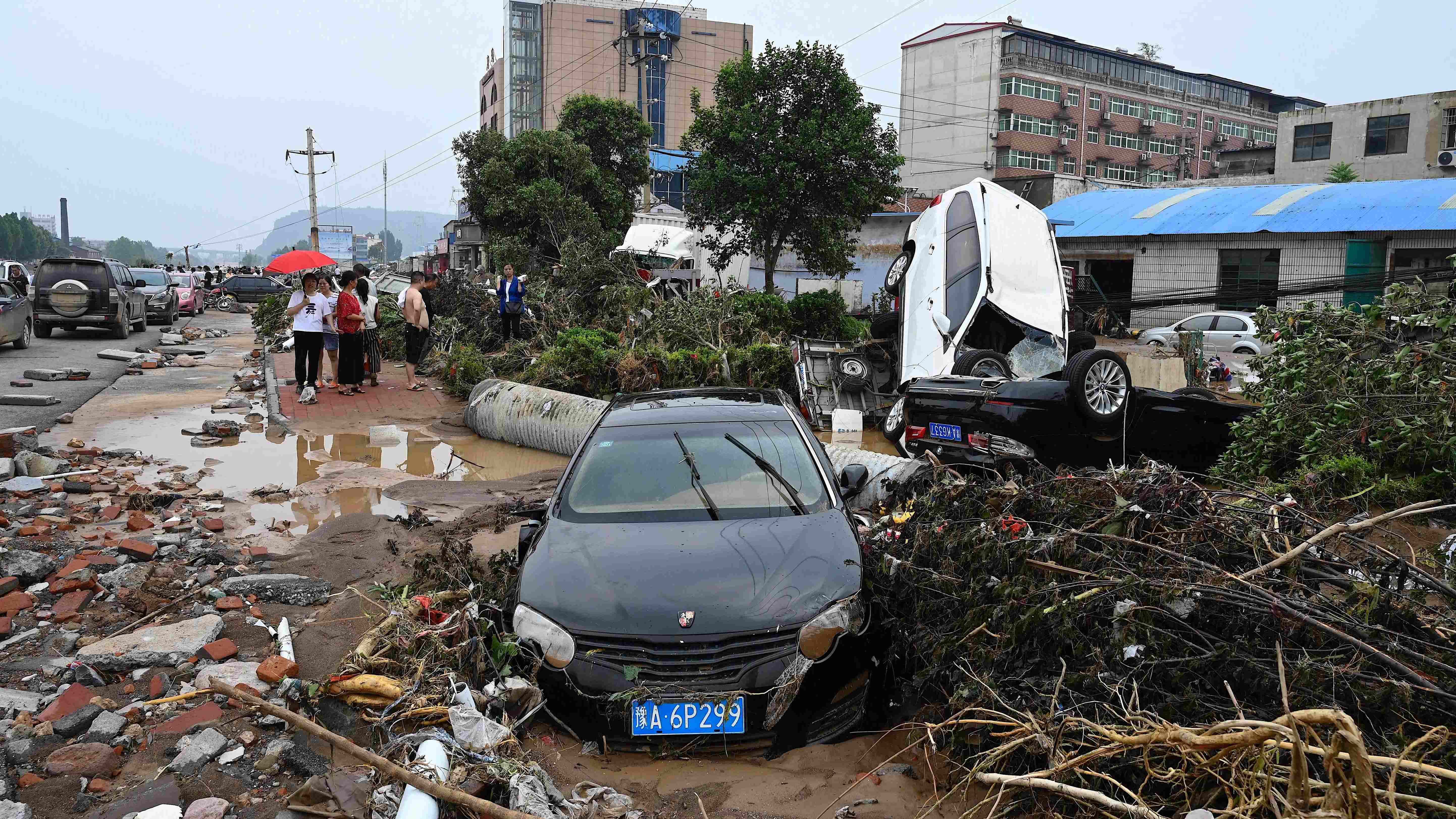 Cars are stuck on a muddy road after severe flooding and landslide in recent days have hit the county-level Gongyi city, near Zhengzhou, in central China’s Henan province on July 22, 2021. Credit: AFP Photo