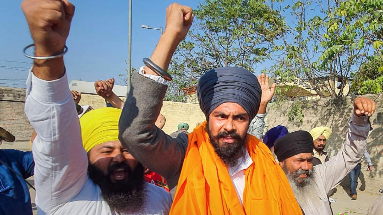 Waris Punjab De' founder Amritpal Singh's associate Lovepreet Toofan raise slogans along with supporters after his release from the Amritsar Central Jail. Credit: PTI Photo