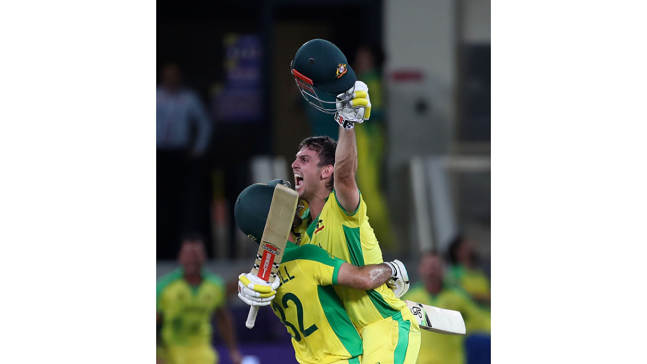 Australia's Glenn Maxwell, left, and Mitchell Marsh celebrate after winning the Cricket Twenty20 World Cup final match against NA. Credit: AP Photo   New Zealand and Australia in Dubai, UAE, Sunday, Nov. 14, 2021. Credit: AP Photo