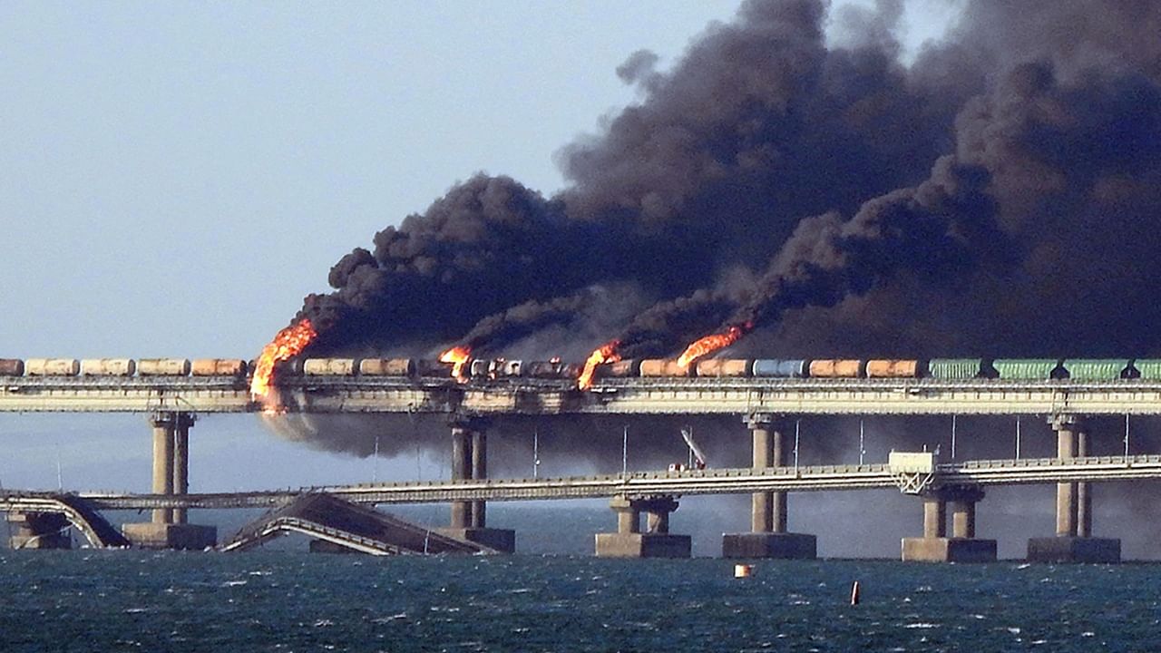 This file photo taken on October 8, 2022 shows black smoke billowing from a fire on the Kerch bridge that links Crimea to Russia, after a truck exploded, near Kerch. Credit: AFP