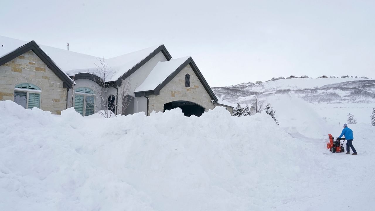 A person removes snow from their driveway in Draper, Utah, on February 23, 2023. Credit: AFP Photo