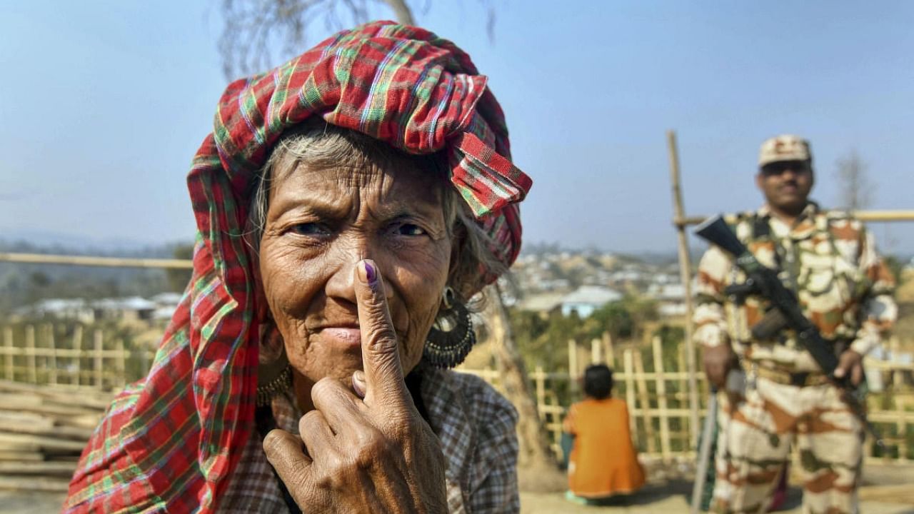 <div class="paragraphs"><p>An elderly voter shows her inked finger after casting her vote.</p></div>