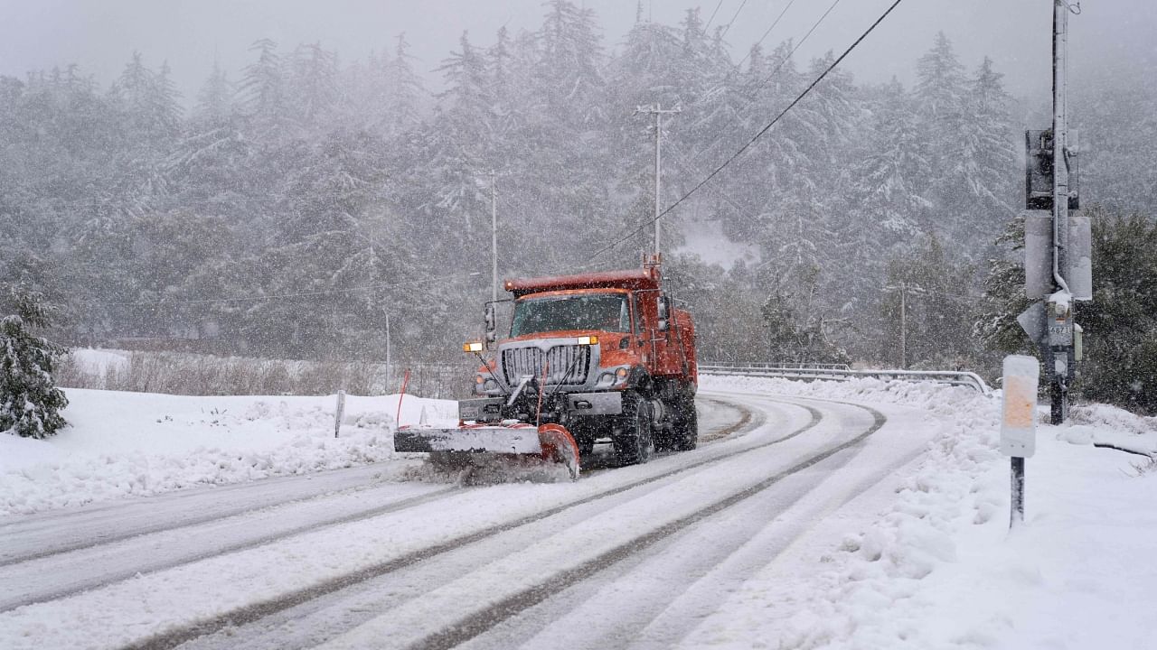 A plow clears snow on Mount Baldy Road in the town of Mount Baldy, California, on February 24, 2023. Credit: AFP Photo