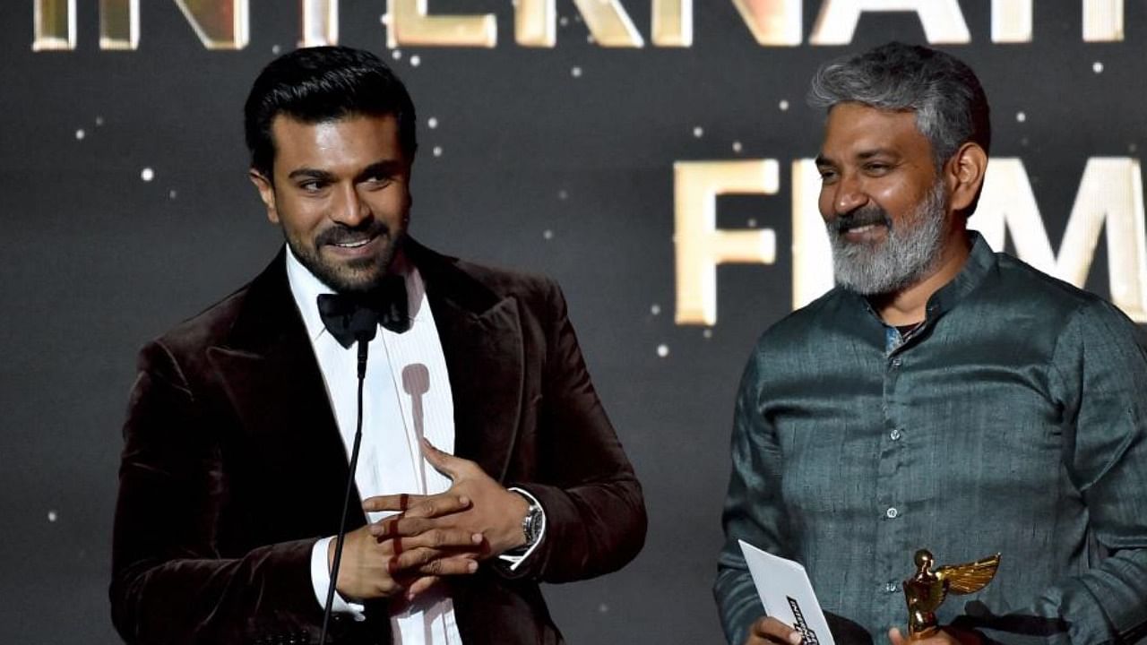 Ram Charan and S S Rajamouli accept the Best International Film award for 'RRR' onstage during the HCA Film Awards in LA. Credit: AFP Photo