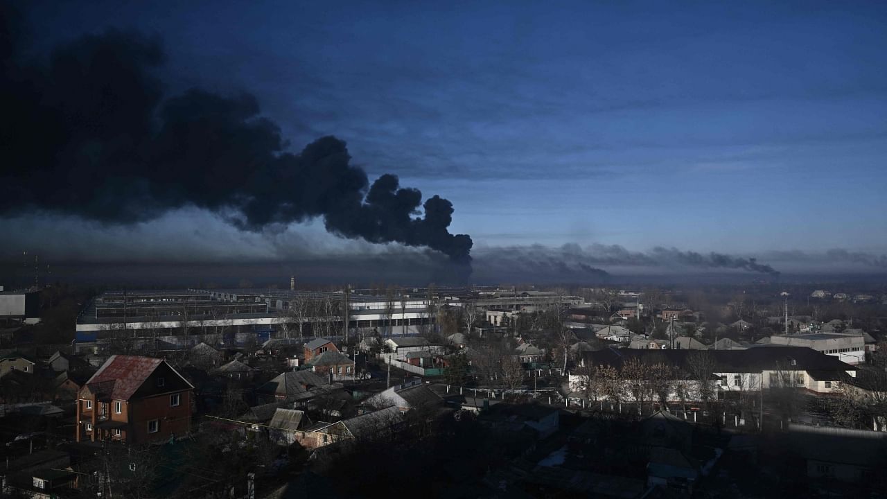 In this file photo taken on February 24, 2022 black smoke rises from a military airport in Chuguyev near Kharkiv. Credit: AFP File Photo