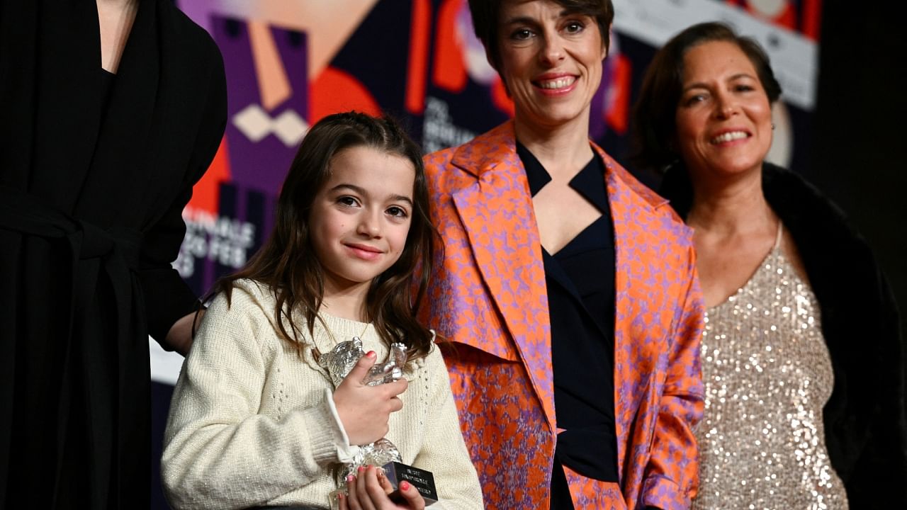 Sofia Otero, winner of the Silver Bear for Best Leading Performance for the film '20,000 Species of Bees', poses with director Estibaliz Urresola Solaguren during a news conference at the 73rd Berlinale International Film Festival in Berlin, Germany, February 25, 2023. Credit: AFP Photo