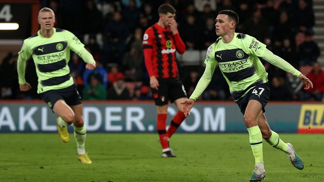 Phil Foden (R) and Erling Haaland (L) celebrate Manchester City's third goal against Bournemouth. Credit: AFP Photo