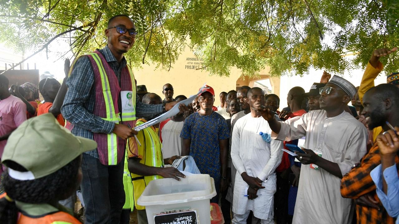 An Independent National Electoral Commission (INEC) official holds up a ballot paper towards part agents during the counting process at a polling station in Yola on February 25, 2023, during Nigeria's presidential and general election. Credit: AFP Photo