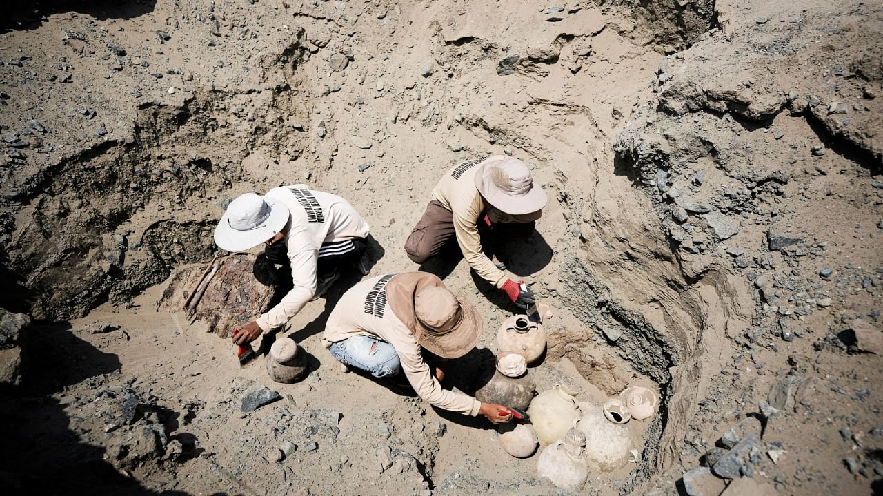 Archaeologists from the University of San Marcos work at the site of a burial belonging to the Chantay pre-Columbian culture, which was found in a cemetery at Macaton mountain in the north-central Huaral valley, in Huaral, Peru February 24, 2023. Credit: Reuters Photo
