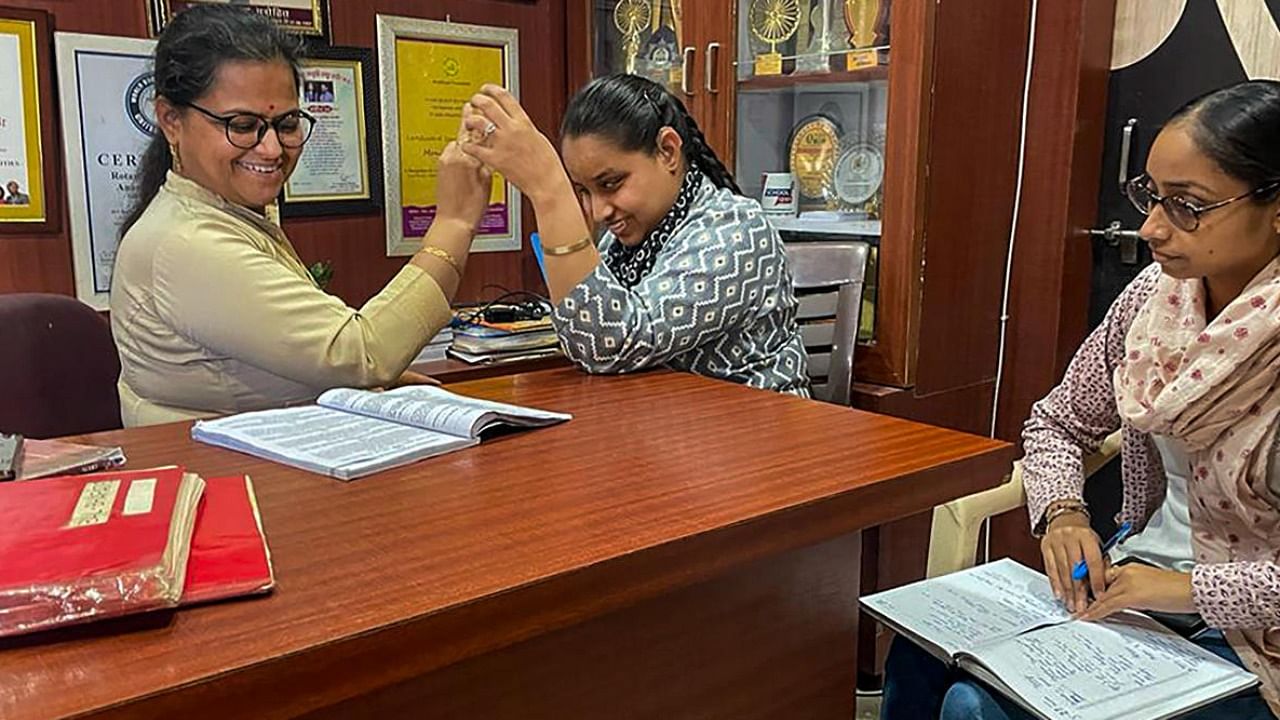 Gurdeep Kaur Vasu, a 32-year-old candidate with disabilities, prepares for Class 10th board exams in Indore. Credit: PTI Photo