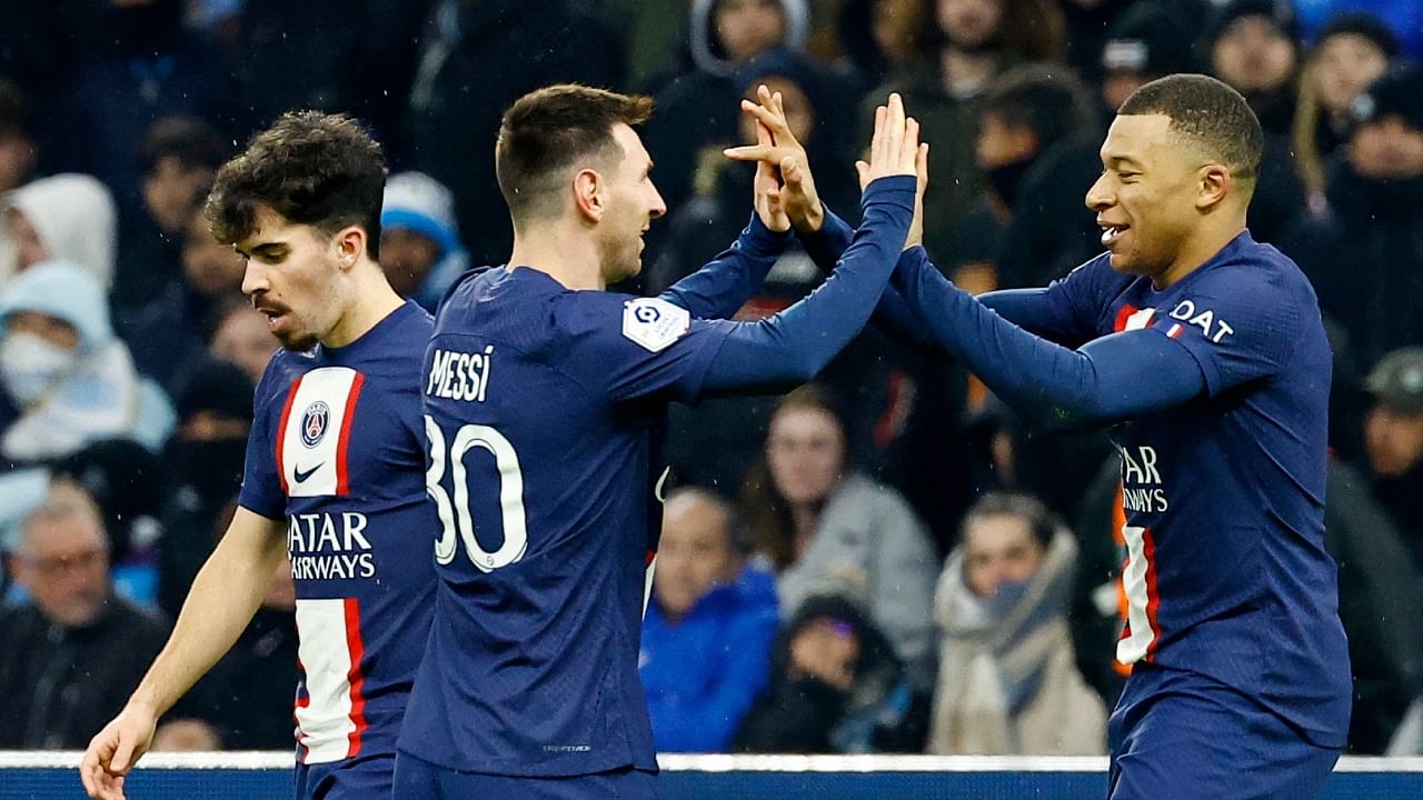 Lionel Messi (C) and Kylian Mbappe (R) celebrate PSG's third goal. Credit: Reuters Photo