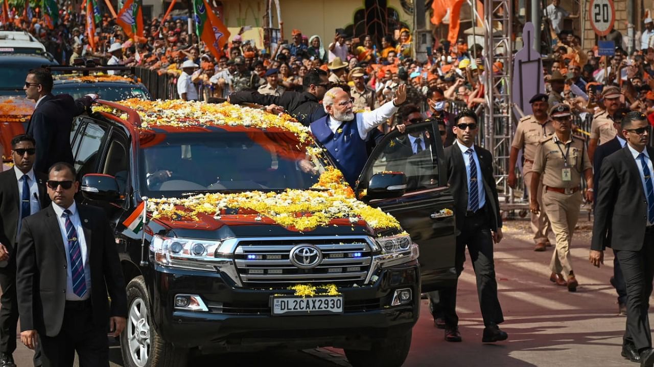 Prime Minister Narendra Modi waves at supporters during a roadshow, in Belagavi, Monday, Feb. 27, 2023. Credit: PTI Photo