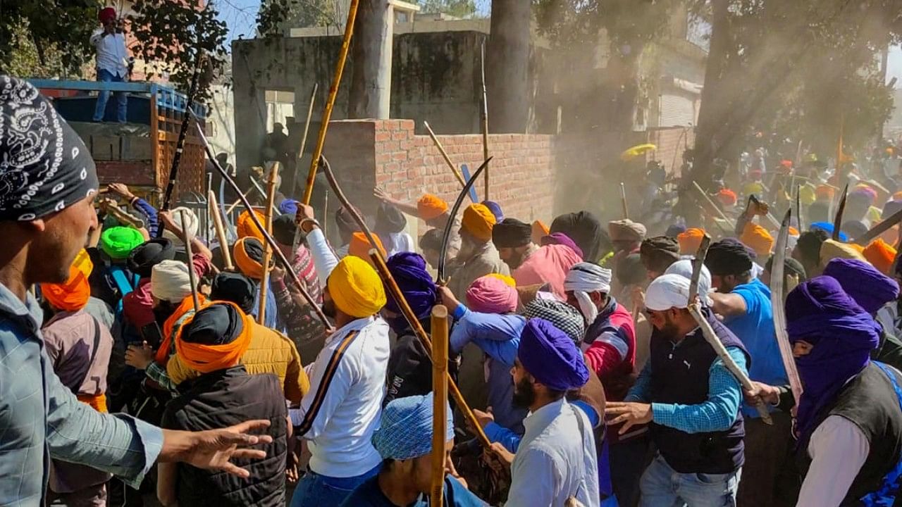 Followers of 'Waris Punjab De' founder Amritpal Singh clash with the police while breaking through barricades at the police in protest against filing of FIR against him and his associates, at Ajnala near Amritsar. Credit: PTI File Photo