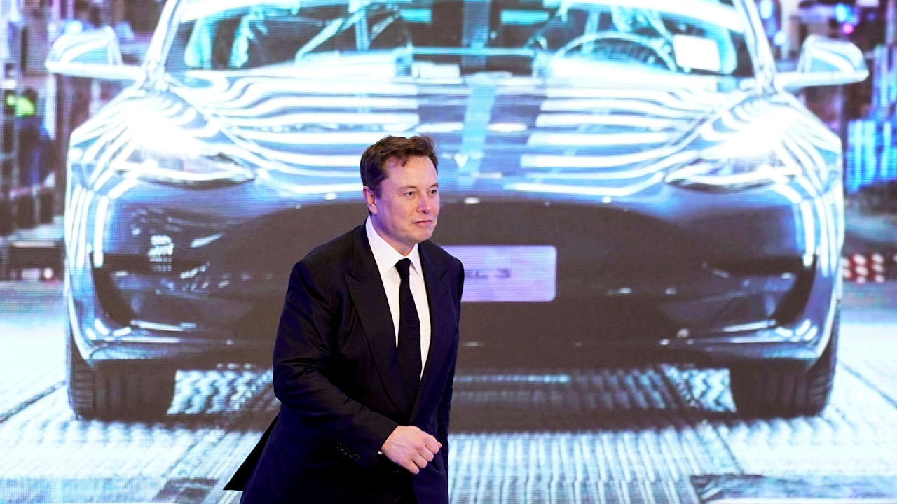 Tesla Inc CEO Elon Musk walks next to a screen showing an image of Tesla Model 3 car during an opening ceremony for Tesla China-made Model Y program in Shanghai. Credit: Reuters Photo