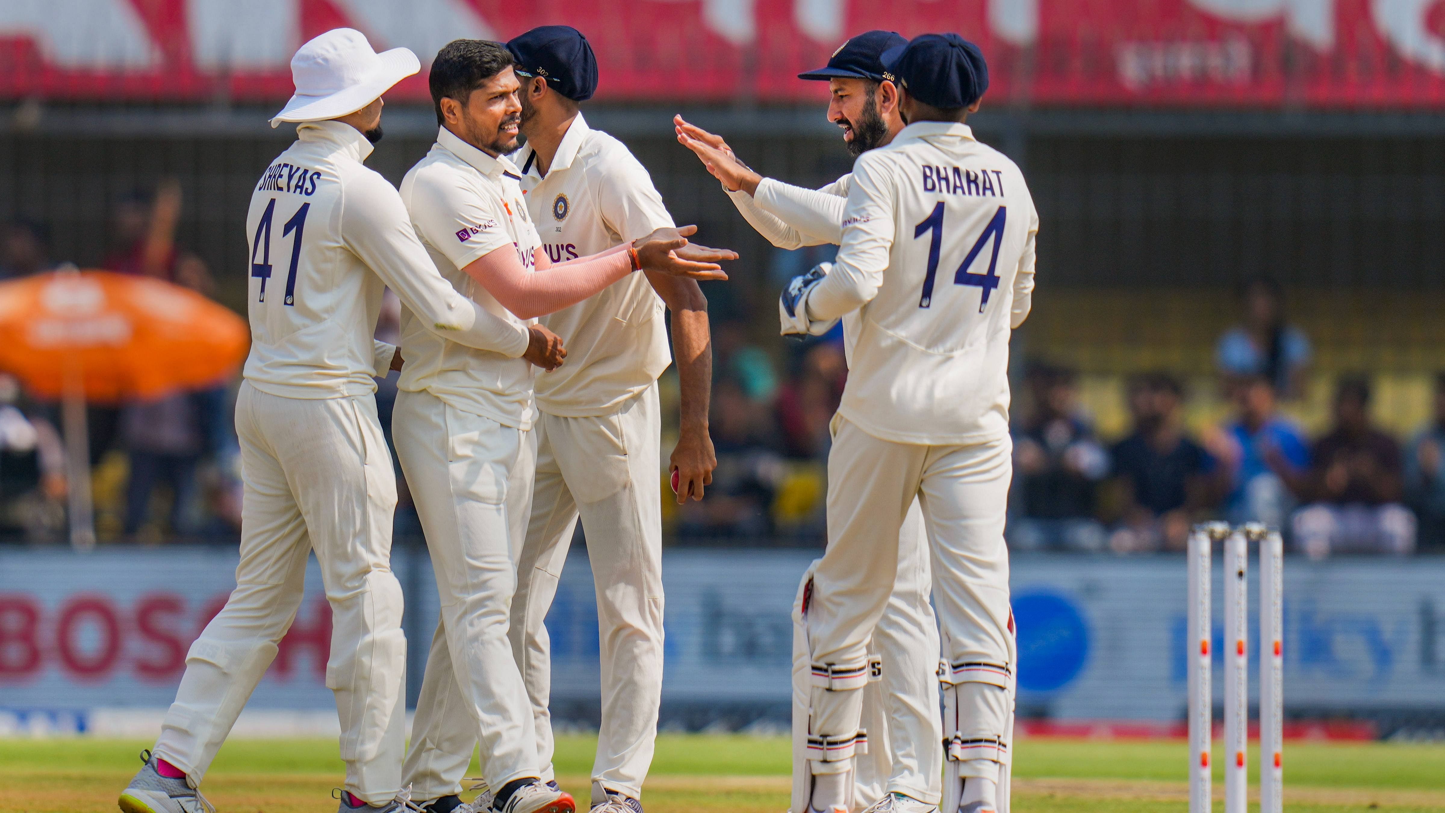 Umesh Yadav celebrates with teammates the wicket of Australian batter Cameron Green during the 2nd day of the 3rd test cricket match in Indore. Credit: PTI Photo