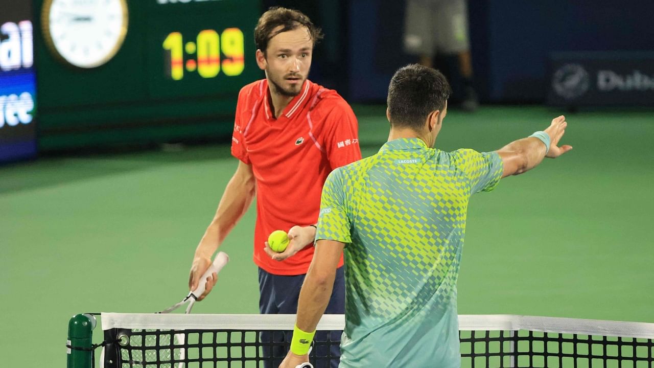 Serbia's Novak Djokovic (R) speaks with Russia's Daniil Medvedev during their ATP Dubai Duty Free Tennis Championship semi-final match in Dubai, on March 3, 2023. Credit: AFP Photo