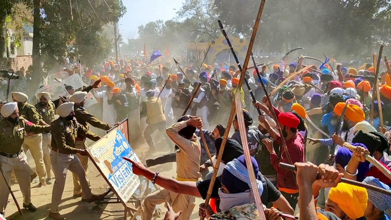 Followers of 'Waris Punjab De' founder Amritpal Singh clash with the police while breaking through barricades at the police in protest against filing of FIR against him and his associates, at Ajnala near Amritsar. Credit: PTI File Photo