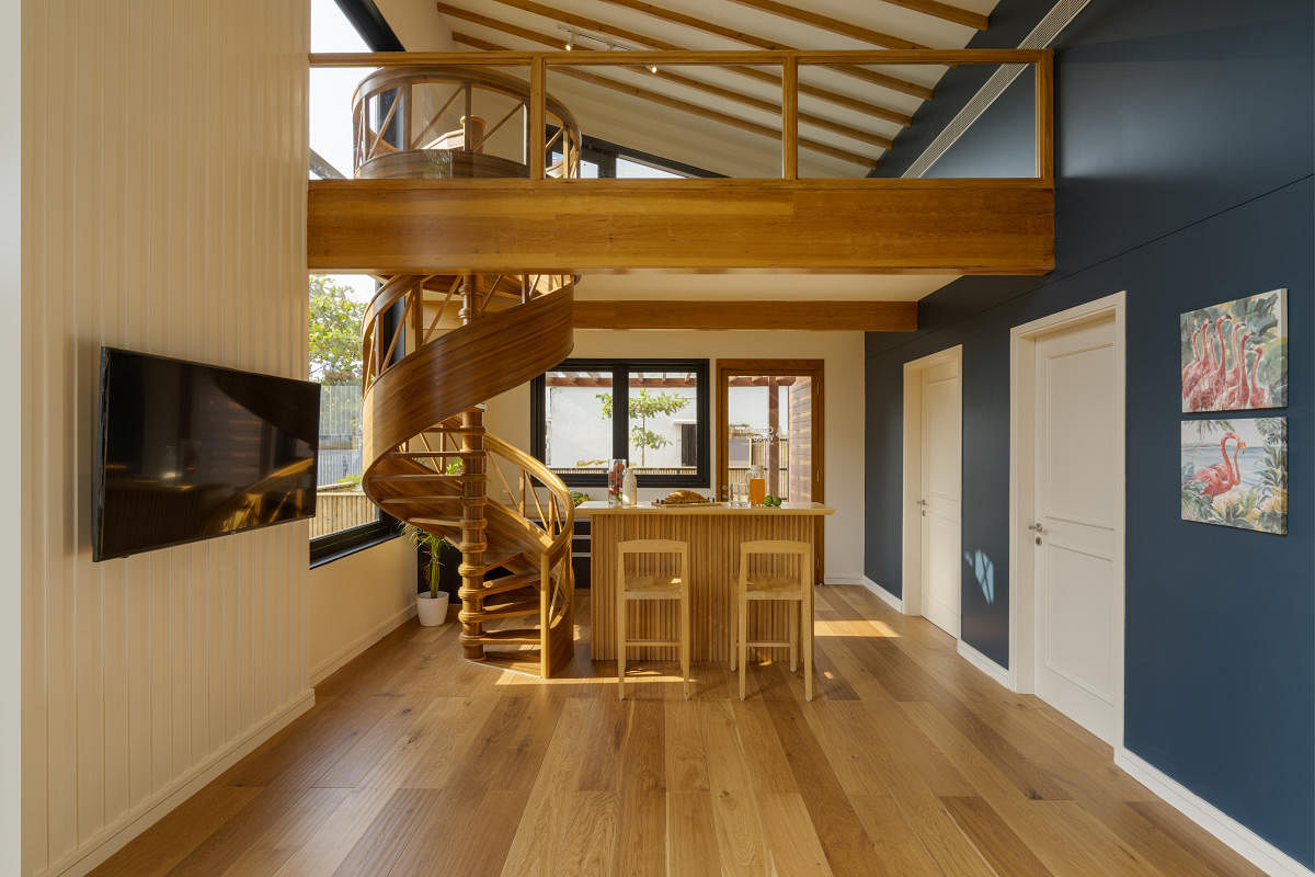 A wooden modular home designed by Woodniido, Chennai. Gypsum boards screwed on top of wood have been painted blue and white to break the monotony.