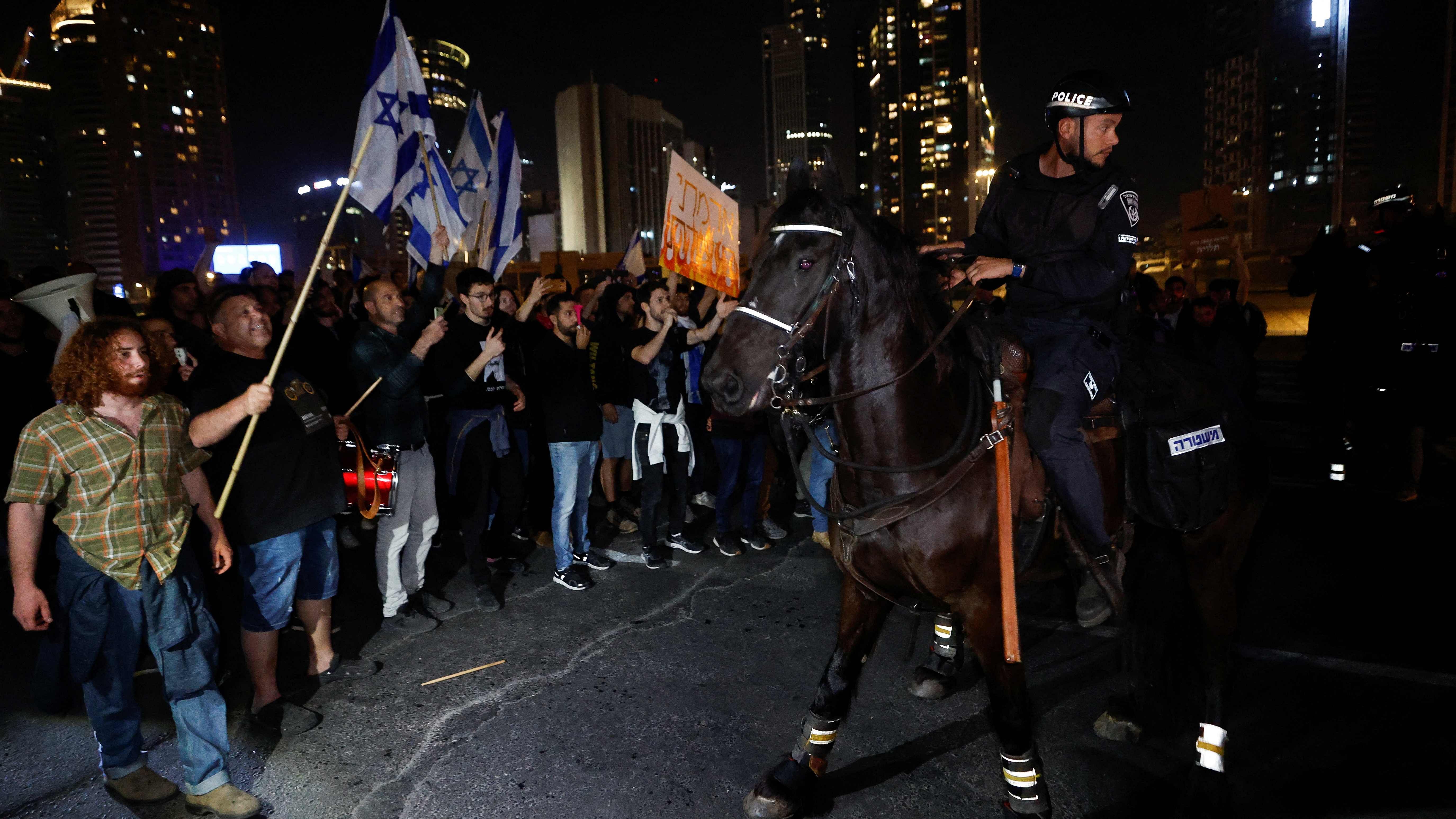 People stand next to mounted police member during a demonstration, as Israeli Prime Minister Benjamin Netanyahu's nationalist coalition government presses on with its contentious judicial overhaul, in Tel Aviv. Credit: Reuters Photo