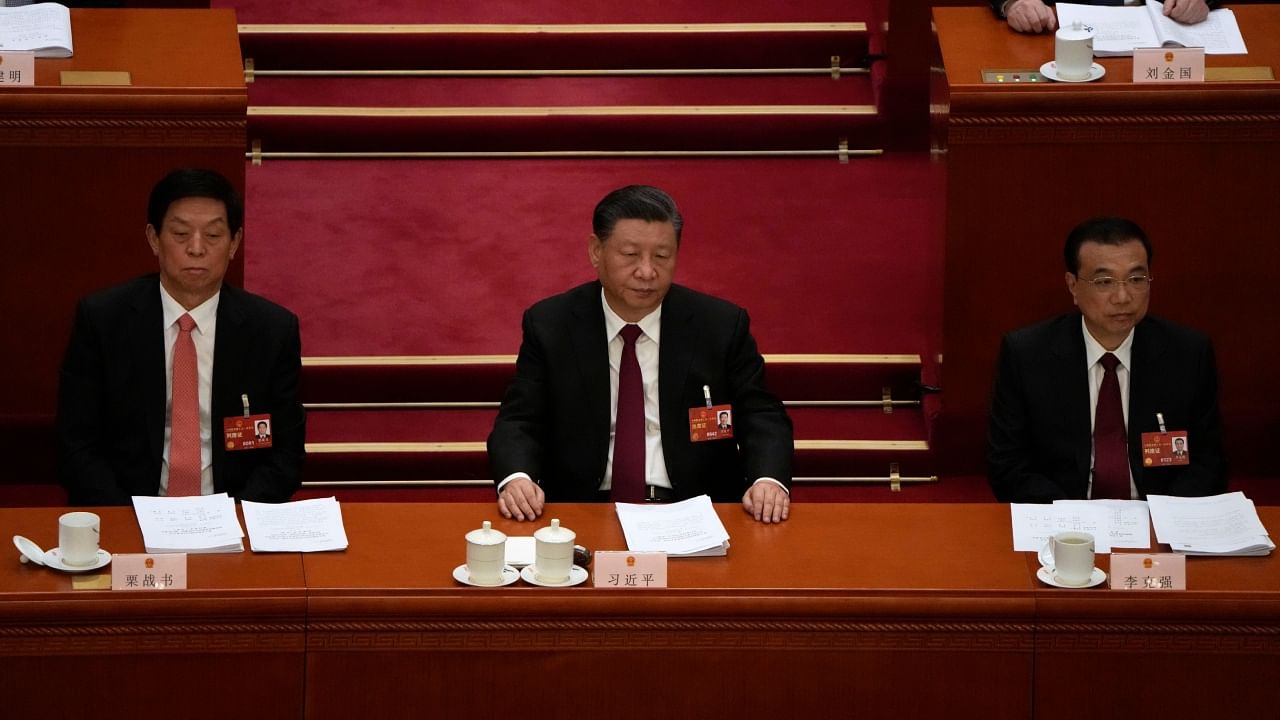 From left, Li Zhanshu, Chinese President Xi Jinping, and Premier Li Keqiang attend the opening session of China's National People's Congress (NPC) at the Great Hall of the People in Beijing, Sunday, March 5, 2023. Credit: PTI/AP Photo
