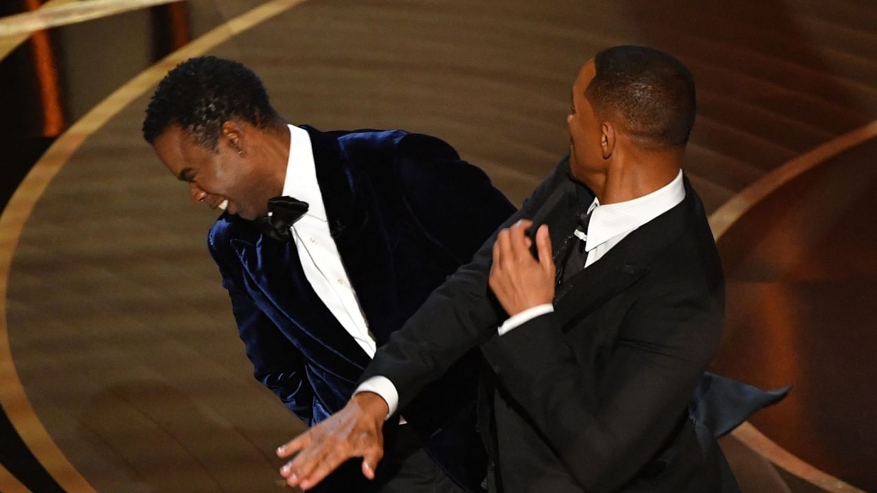  In this file photo taken on March 27, 2022 US actor Will Smith (R) slaps US actor Chris Rock onstage during the 94th Oscars at the Dolby Theatre in Hollywood, California. Credit: AFP File Photo