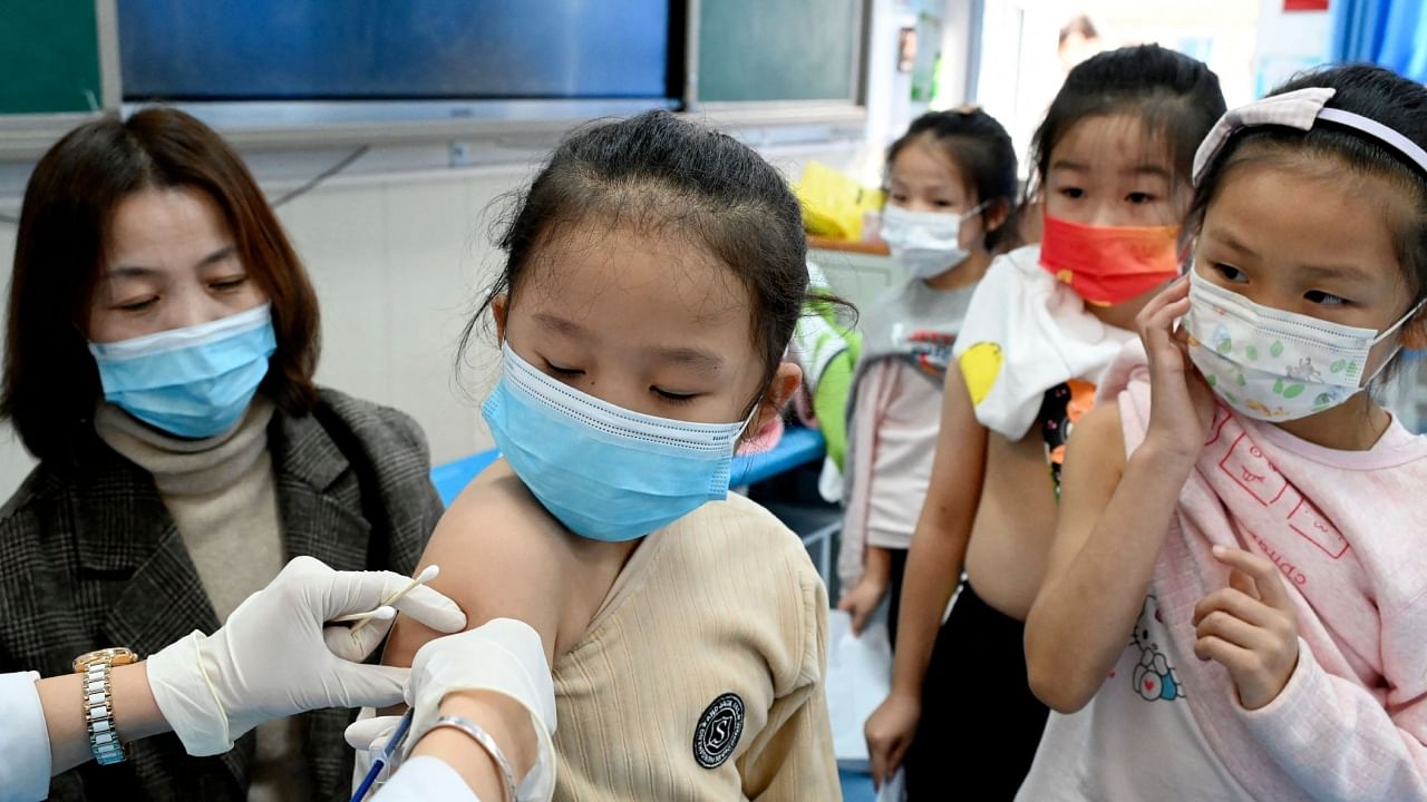  A child receives the Covid-19 vaccine at a school in Handan, in China's northern Hebi province on October 27, 2021. Credit: AFP Photo