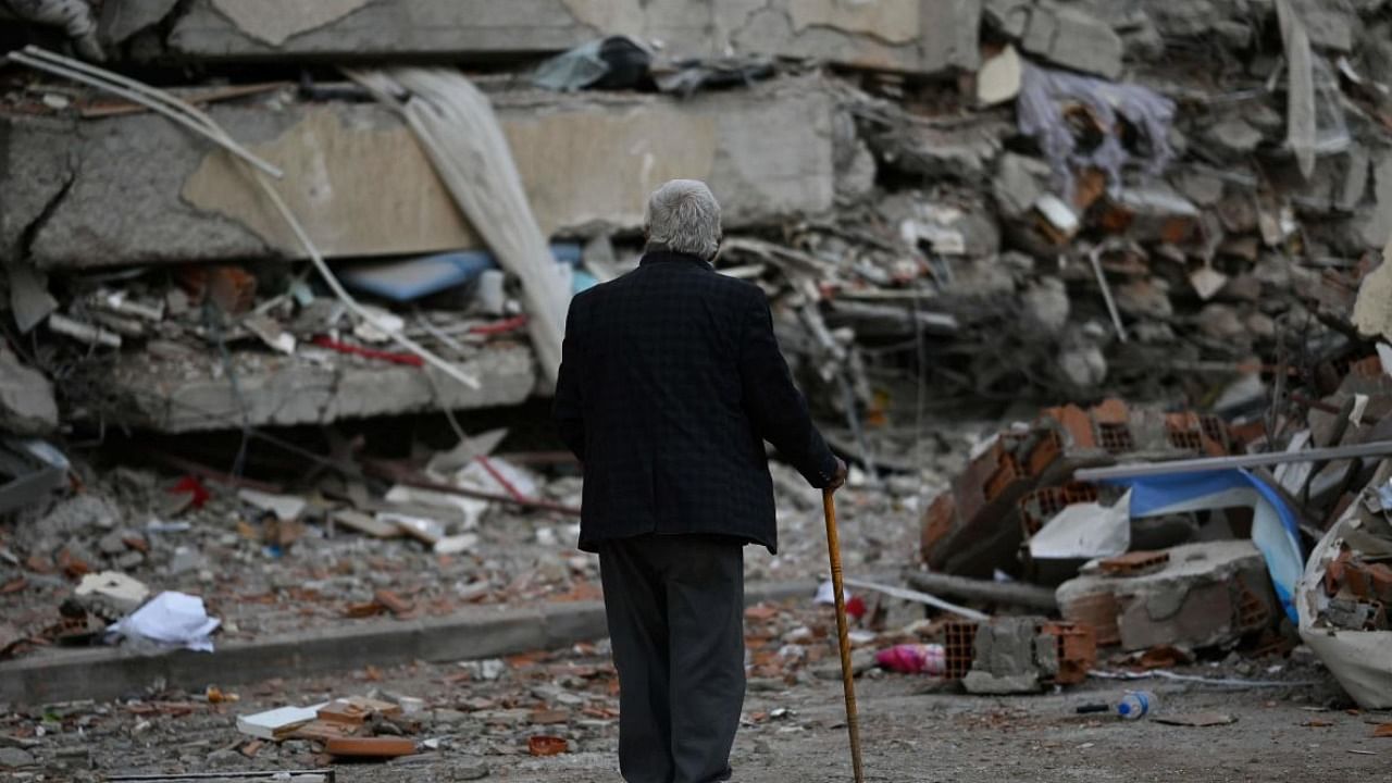 A man walks among debris of collapsed buildings in Kahramanmaras in south-east Turkey. Credit: AFP Photo