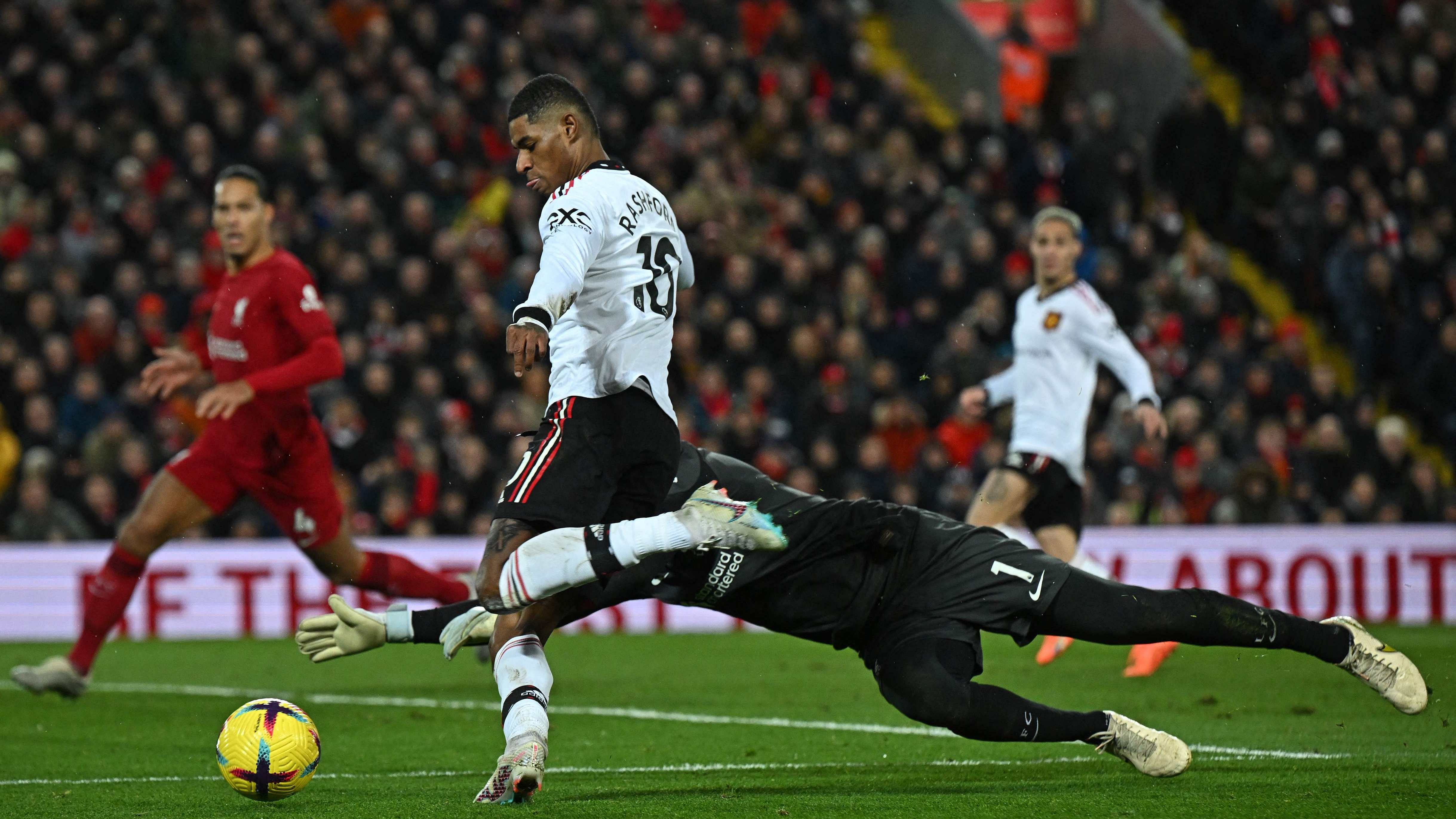 Manchester United's English striker Marcus Rashford (2L) goes around Liverpool's Brazilian goalkeeper Alisson Becker but fails to score during the English Premier League football match between Liverpool and Manchester United at Anfield in Liverpool. Credit: AFP Photo