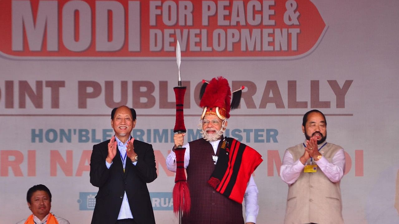 Prime Minister Narendra Modi after being presented with Naga traditional attires by Nagaland Chief Minister Neiphiu Rio (L) during a public rally ahead of the Nagaland Assembly election in Chumukedima, Nagaland. Credit: PTI File Photo