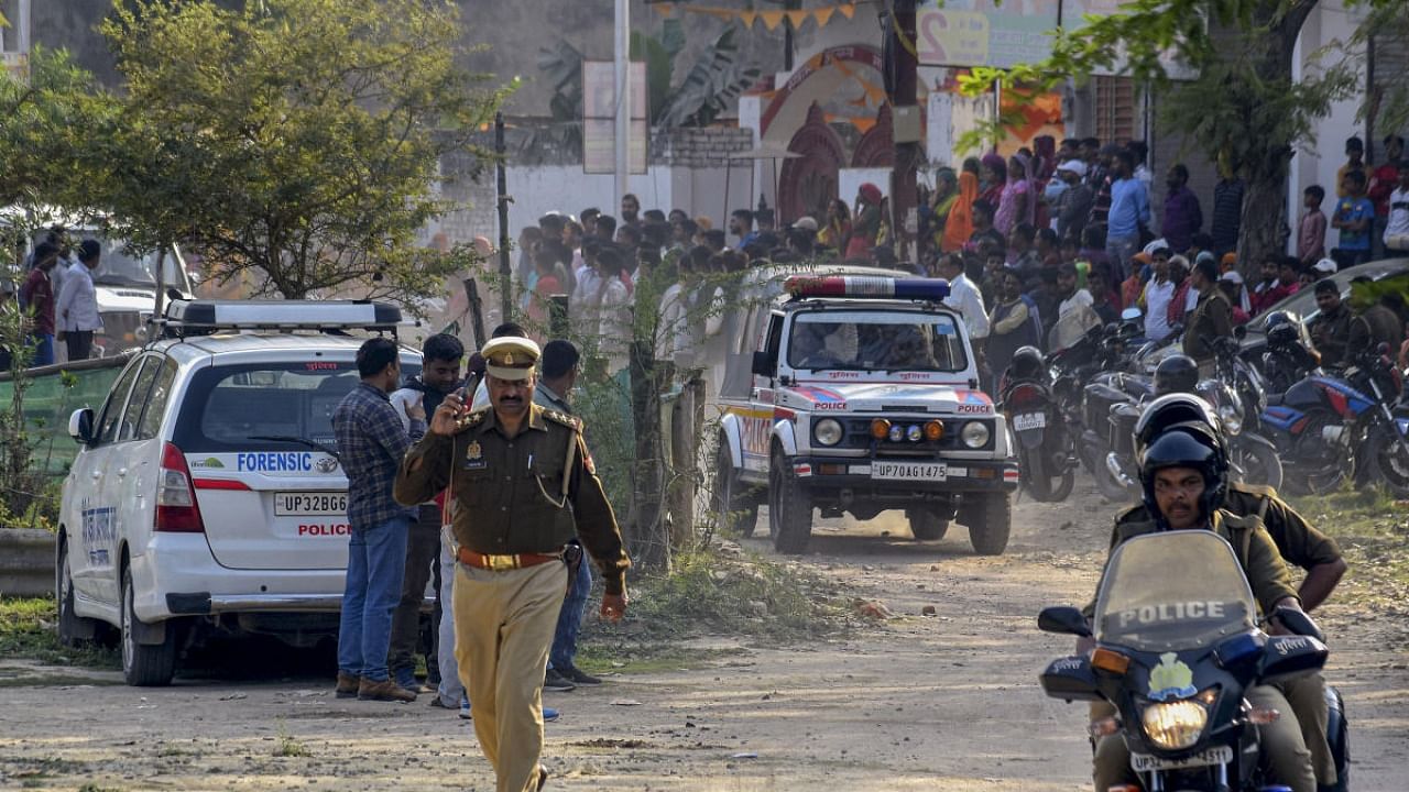 Policemen on the spot where Arbaaz, suspect in Umesh Pal's killing, was killed in an encounter, in Prayagraj, Monday, Feb. 27, 2023. Umesh Pal was the key witness in the former BSP MLA Raju Pal's murder case. Credit: PTI Photo