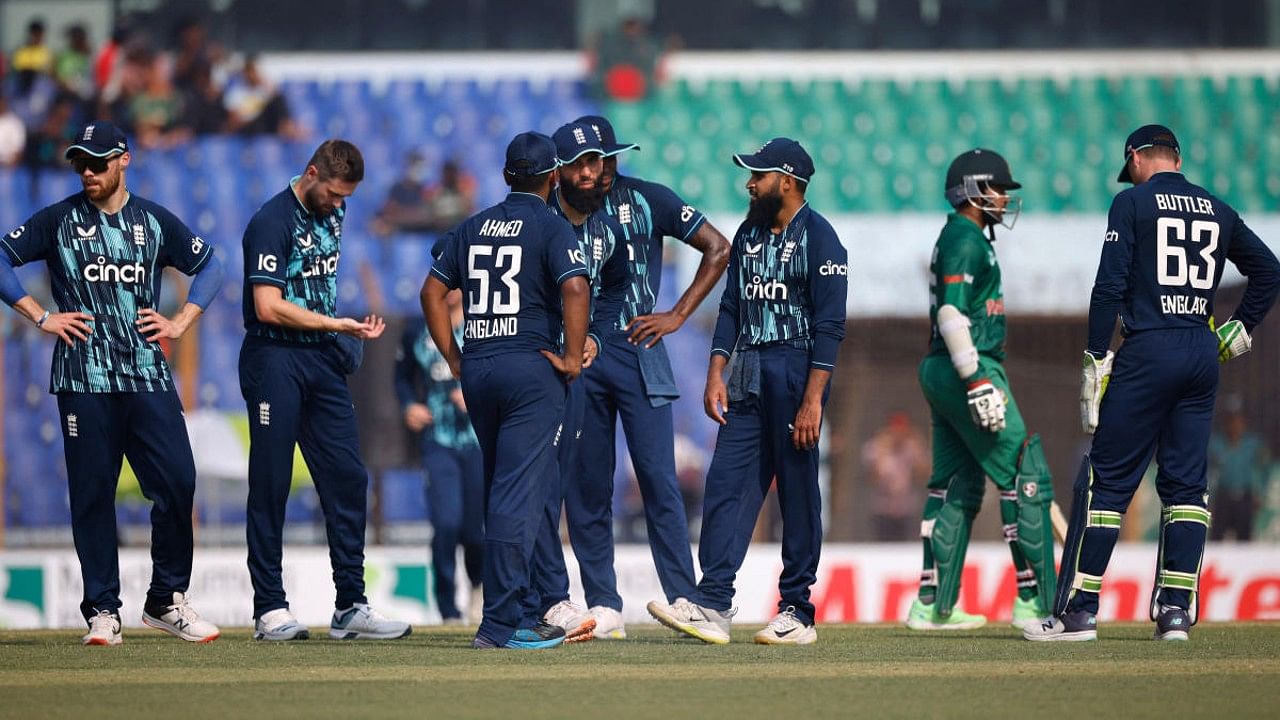 England's Chris Woakes celebrates with teammates after taking the wicket of Bangladesh's Afif Hossain. Credit: Reuters Photo